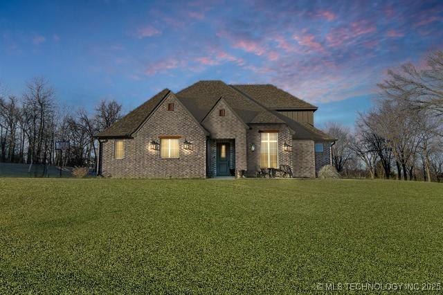 french provincial home featuring a yard