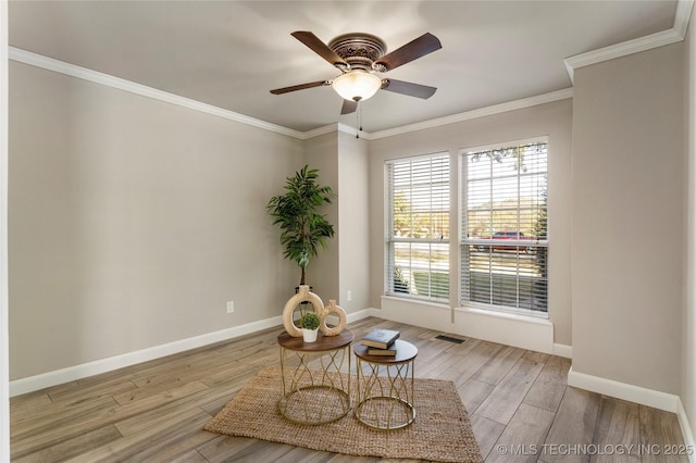 sitting room featuring ornamental molding, ceiling fan, and light wood-type flooring