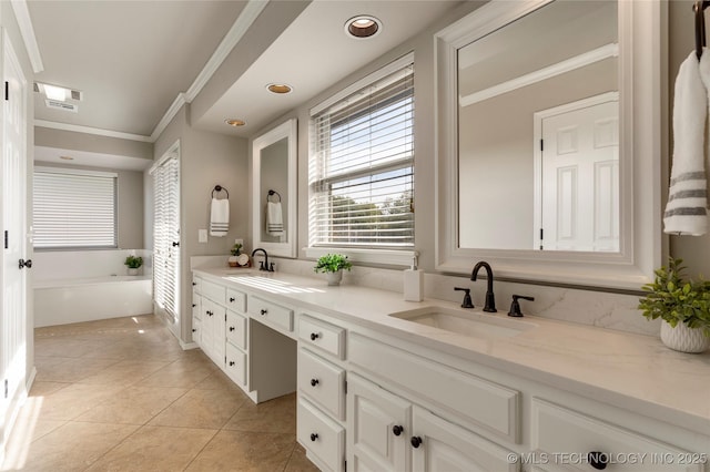 bathroom featuring ornamental molding, vanity, tile patterned flooring, and a washtub