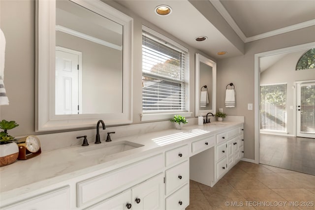 bathroom featuring vanity, tile patterned flooring, a wealth of natural light, and ornamental molding