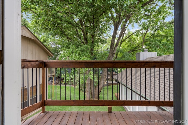 wooden deck featuring a lawn