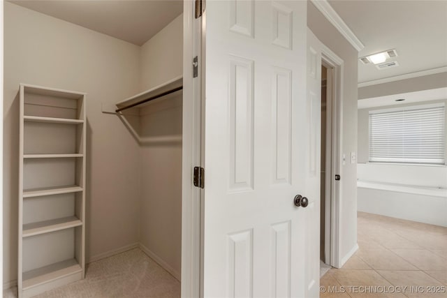 walk in closet featuring light tile patterned floors