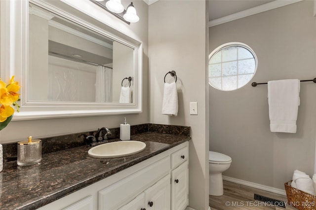 bathroom featuring hardwood / wood-style floors, vanity, ornamental molding, toilet, and a shower with curtain