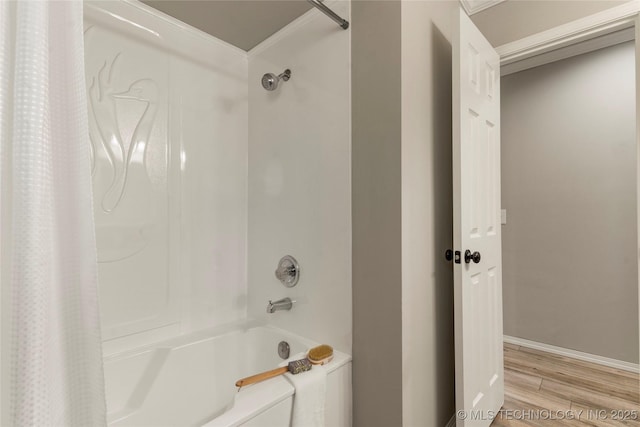 bathroom featuring wood-type flooring and shower / bath combo