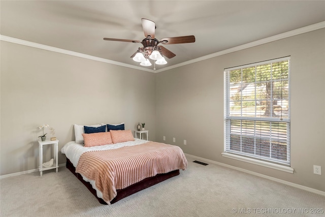 bedroom with crown molding, ceiling fan, and carpet flooring