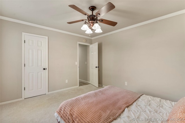 carpeted bedroom featuring ornamental molding and ceiling fan