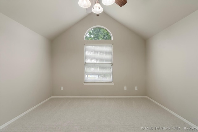 unfurnished room with lofted ceiling, ceiling fan, and carpet flooring