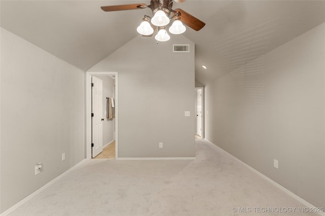 interior space featuring vaulted ceiling, light carpet, and ceiling fan