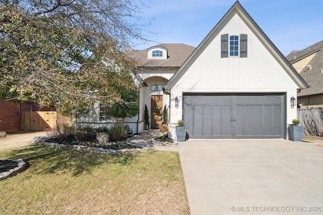 view of front of house featuring a garage and a front lawn