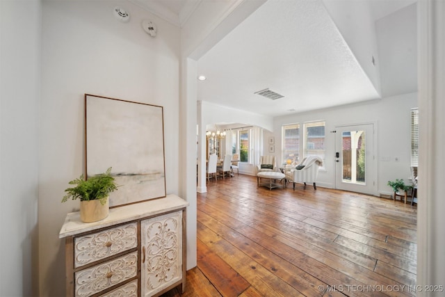 entryway featuring an inviting chandelier and hardwood / wood-style floors