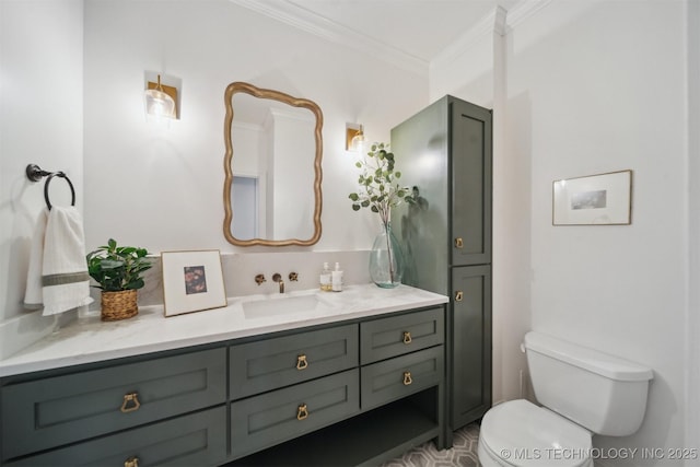 bathroom with vanity, crown molding, and toilet