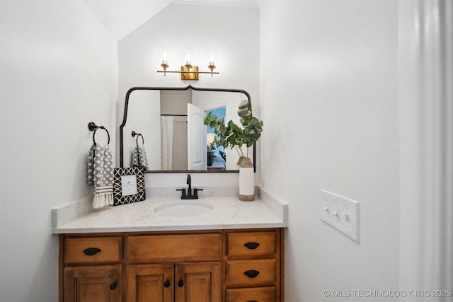 bathroom with vanity and vaulted ceiling