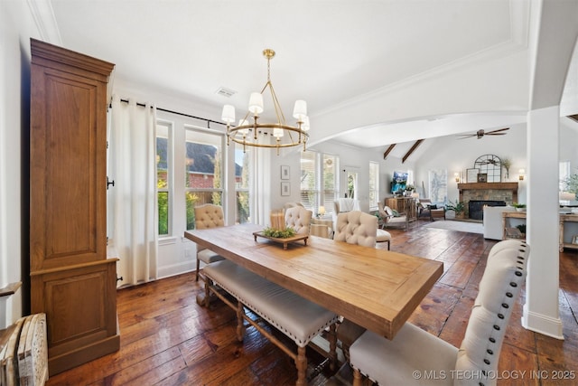 dining area with lofted ceiling with beams, crown molding, a fireplace, and dark hardwood / wood-style flooring