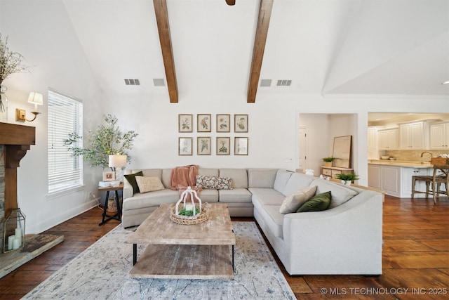 living room featuring high vaulted ceiling, dark wood-type flooring, and beam ceiling