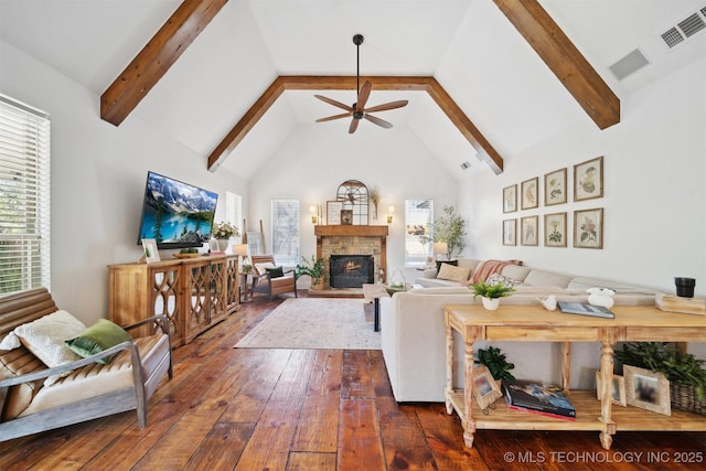 living room featuring ceiling fan, beam ceiling, high vaulted ceiling, dark hardwood / wood-style floors, and a fireplace