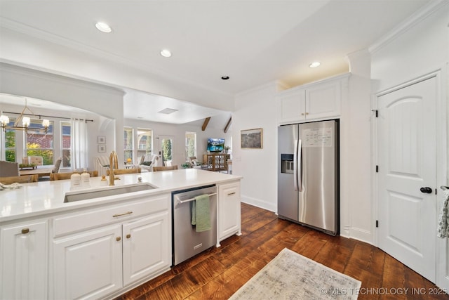 kitchen featuring sink, white cabinetry, a chandelier, appliances with stainless steel finishes, and dark hardwood / wood-style flooring