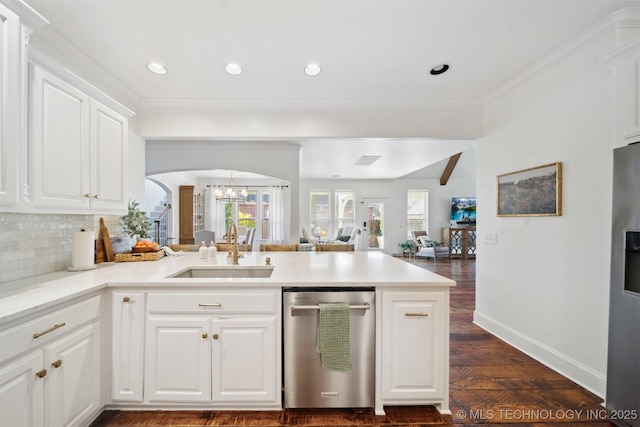 kitchen featuring appliances with stainless steel finishes, kitchen peninsula, sink, and white cabinets