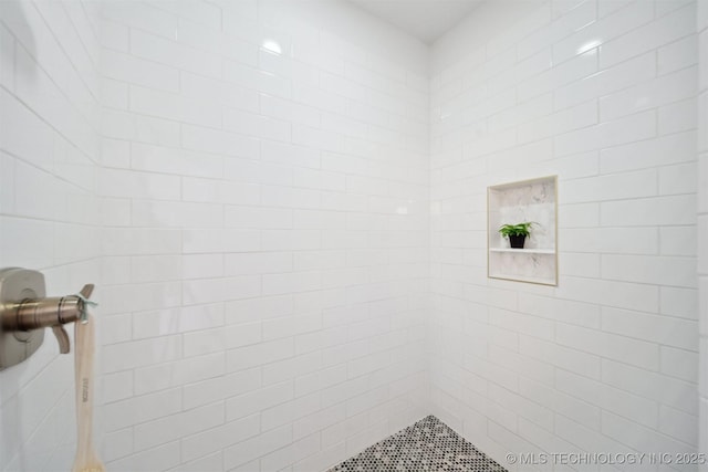 bathroom with tiled shower