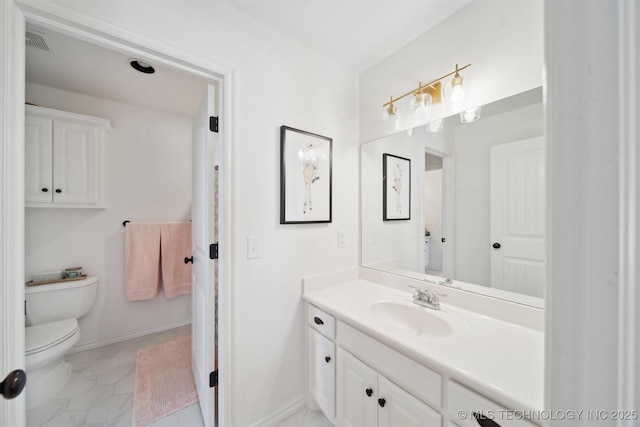 bathroom featuring vanity and toilet