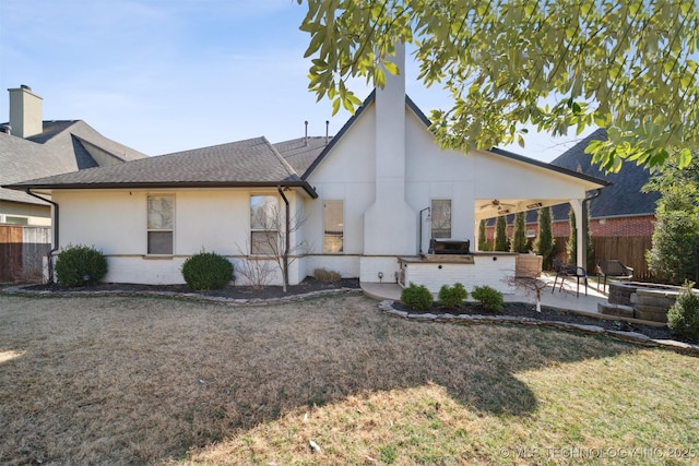 rear view of house featuring a patio, a yard, and ceiling fan