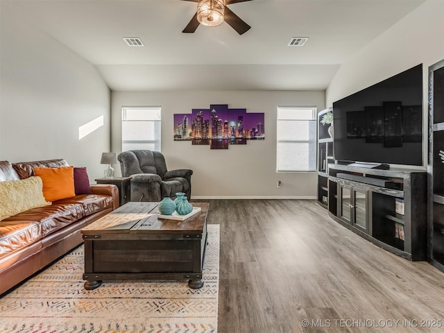 living room with lofted ceiling, hardwood / wood-style flooring, plenty of natural light, and ceiling fan