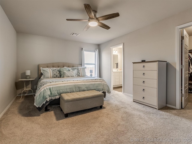 carpeted bedroom with ceiling fan and ensuite bathroom