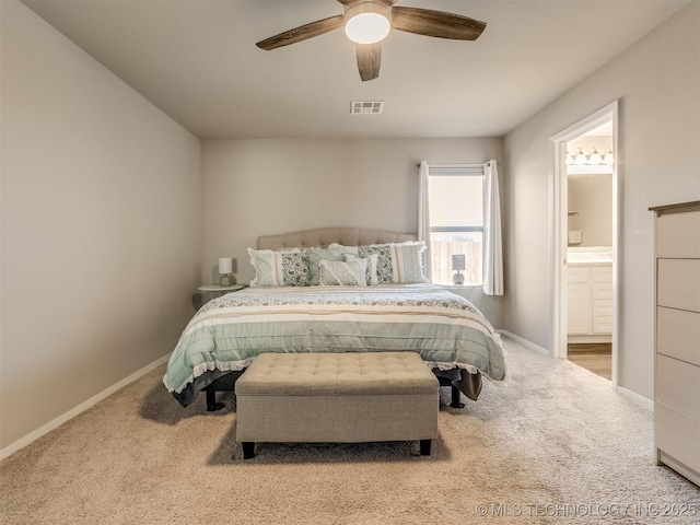 carpeted bedroom with ceiling fan and ensuite bathroom