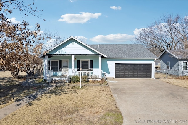 view of front of home with a porch, a garage, and a front yard