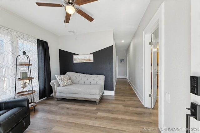 sitting room with ceiling fan and light hardwood / wood-style floors