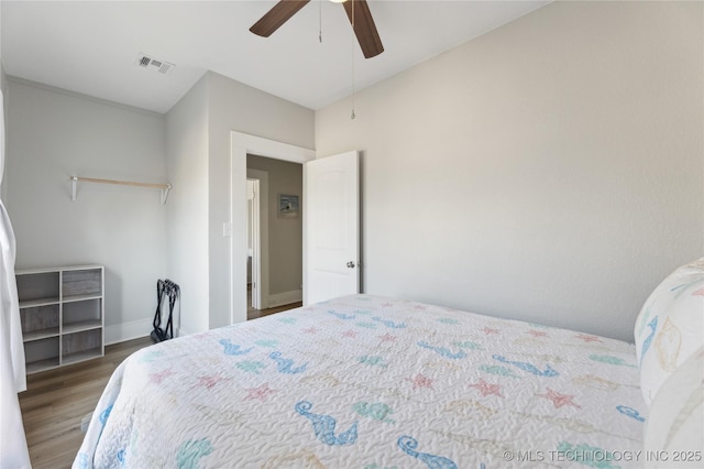 bedroom featuring ceiling fan and dark hardwood / wood-style floors