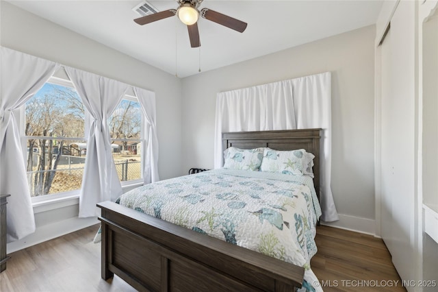 bedroom with dark wood-type flooring and ceiling fan