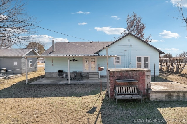 back of house featuring a yard and a patio