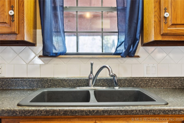 interior details featuring tasteful backsplash and sink