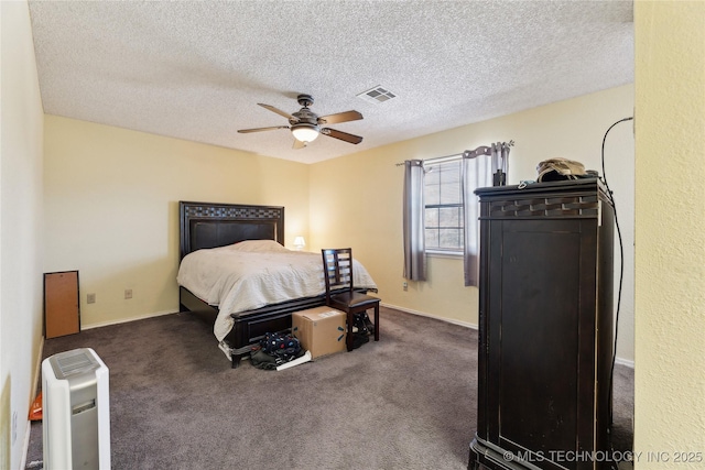 carpeted bedroom featuring a textured ceiling and ceiling fan