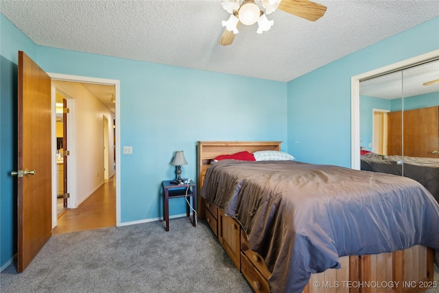 bedroom featuring ceiling fan, carpet flooring, and a textured ceiling