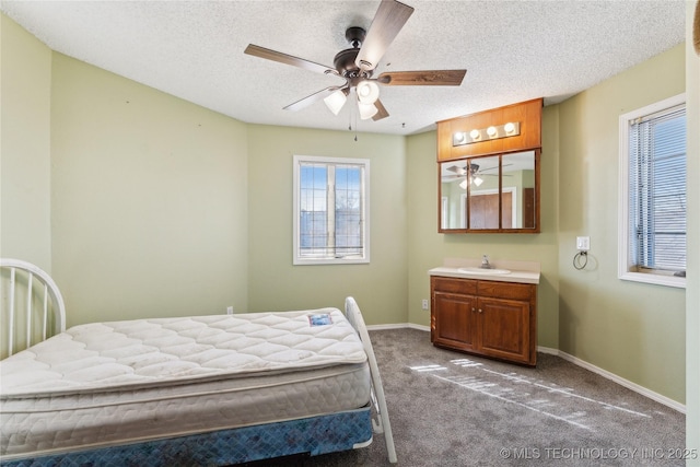 carpeted bedroom featuring sink, a textured ceiling, and ceiling fan