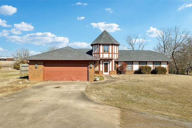 view of front of property with a garage and a front yard