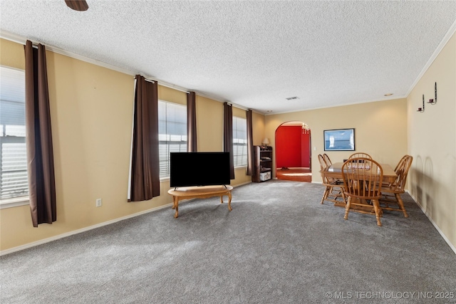 carpeted dining area with ornamental molding and a textured ceiling