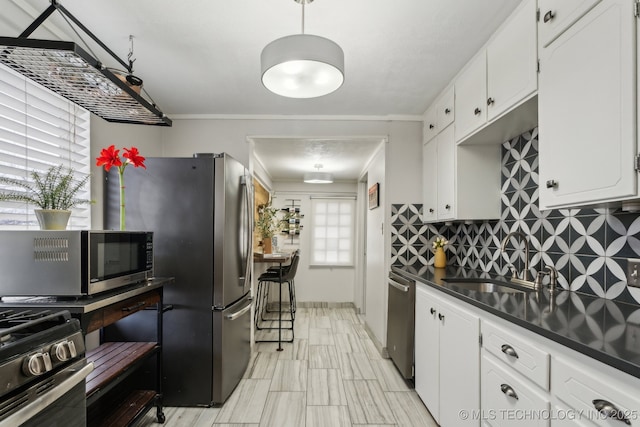 kitchen featuring white cabinetry, sink, decorative backsplash, and appliances with stainless steel finishes