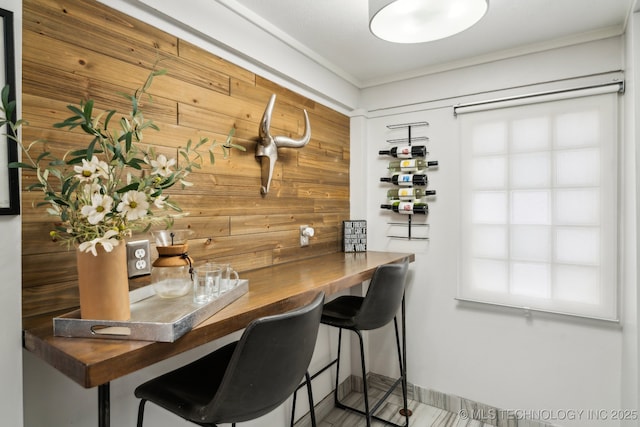 interior space with crown molding, wood counters, and wood walls