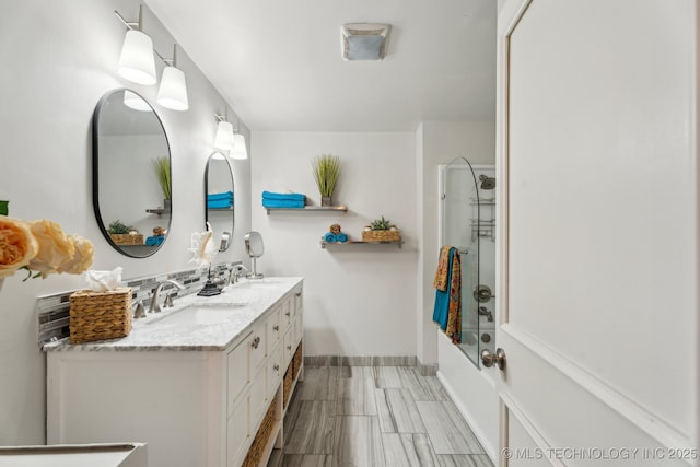 bathroom with vanity and bathtub / shower combination