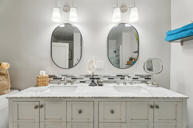 bathroom featuring tasteful backsplash and vanity