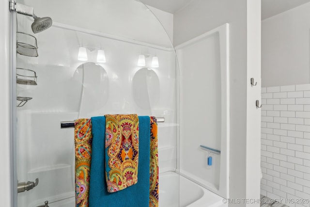 bathroom featuring tile walls and shower / bath combination