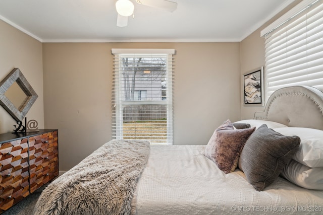 bedroom with ornamental molding and ceiling fan