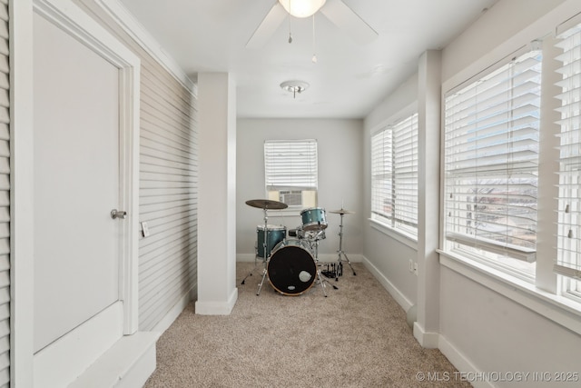 misc room with light carpet, cooling unit, and ceiling fan