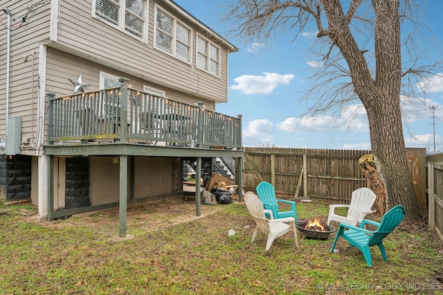 view of yard with a deck and an outdoor fire pit