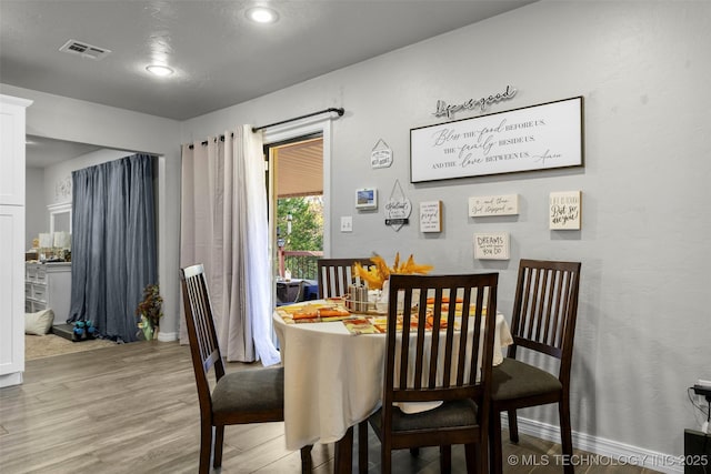 dining area featuring light wood-type flooring