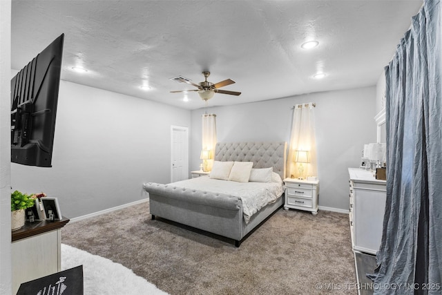 carpeted bedroom featuring a textured ceiling and ceiling fan