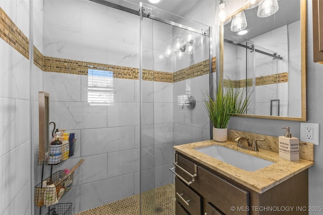 bathroom featuring vanity and a shower with door