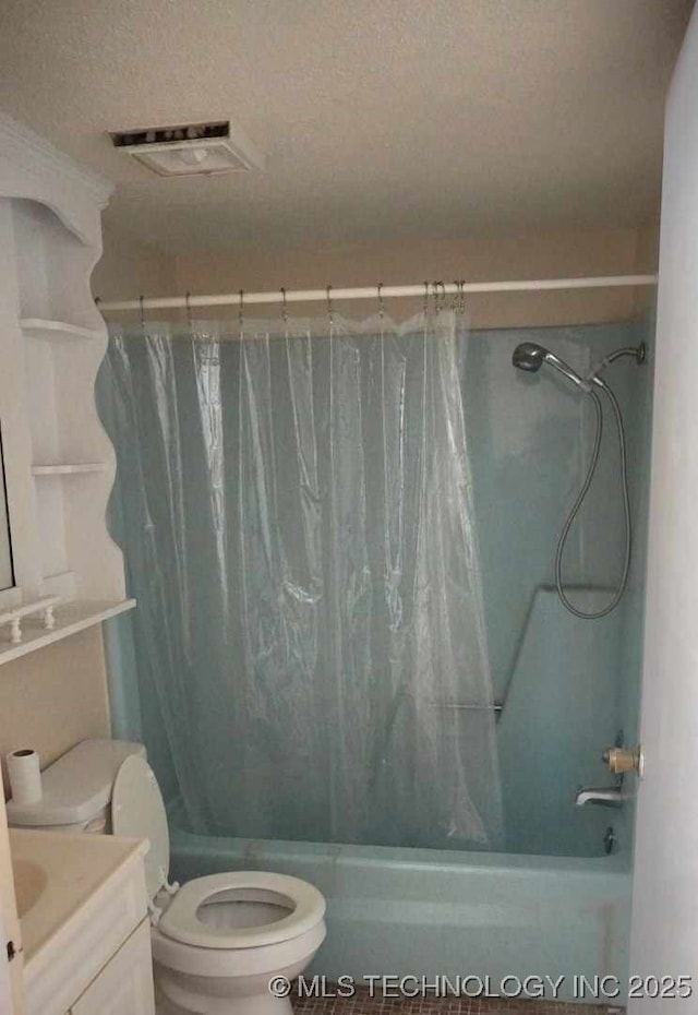 full bathroom with vanity, a textured ceiling, shower / bath combo with shower curtain, and toilet